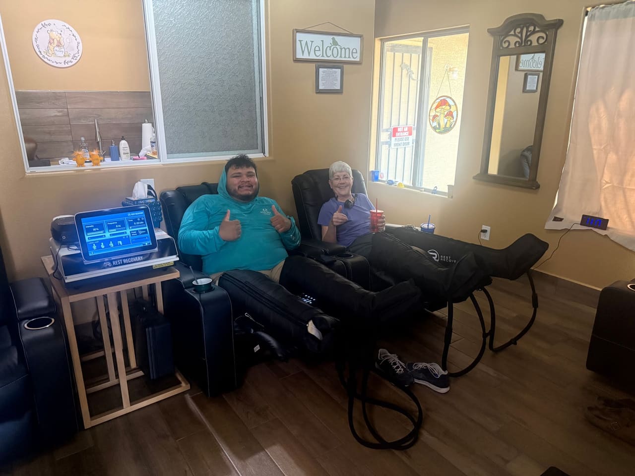 Members using compression therapy in the recovery chairs